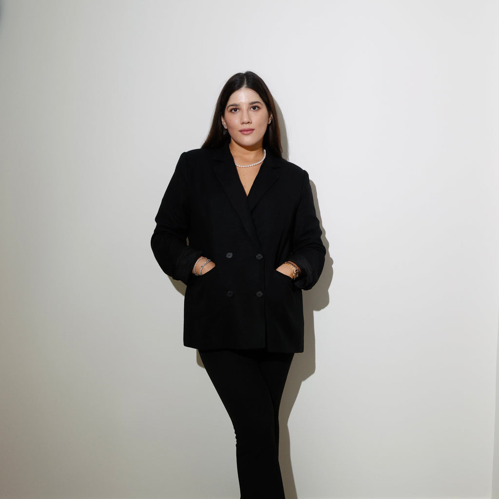 Maria Elisa Franco, founder of MEF Strategy, standing confidently in black blazer