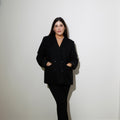 Maria Elisa Franco, founder of MEF Strategy, standing confidently in black blazer