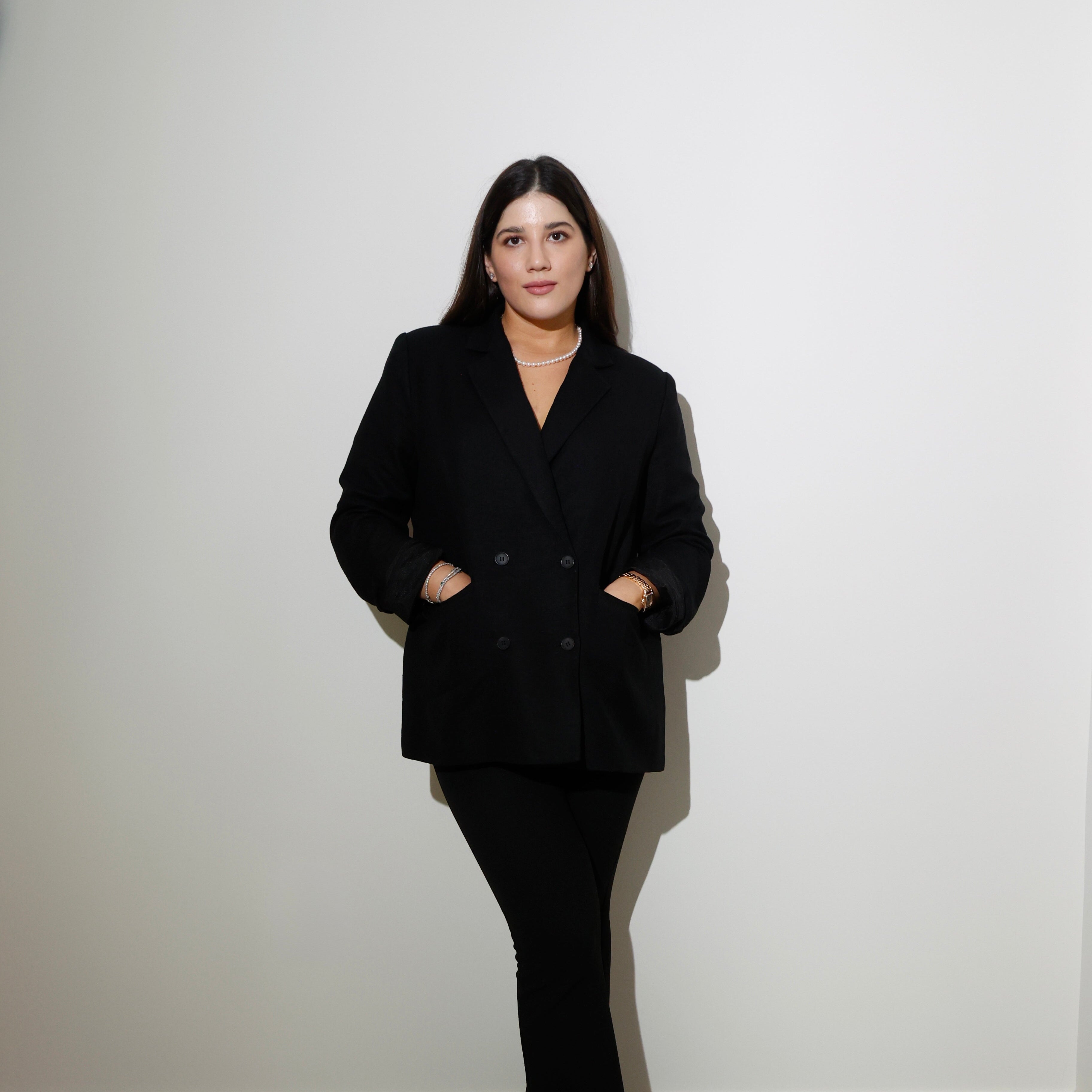 Maria Elisa Franco, founder of MEF Strategy, standing confidently in black blazer
