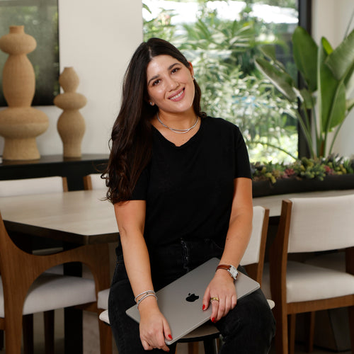 founder smiling holding computer after finishing working hard
