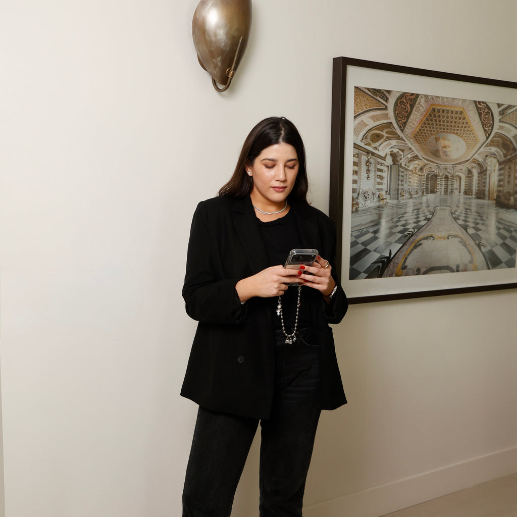 Maria Elisa Franco, founder of MEF Strategy, reviewing social media content on her phone
