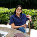 Maria Elisa Franco, founder of MEF Strategy, reviewing content on her phone outdoors