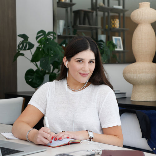 Maria Elisa Franco, founder of MEF Strategy, on a call while managing email campaigns