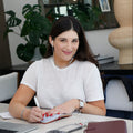 Maria Elisa Franco, founder of MEF Strategy, on a call while managing email campaigns